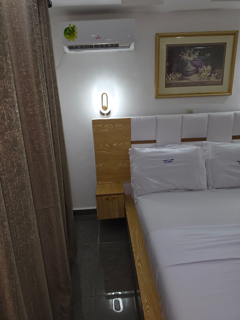 Bedside detail with air conditioning and framed art