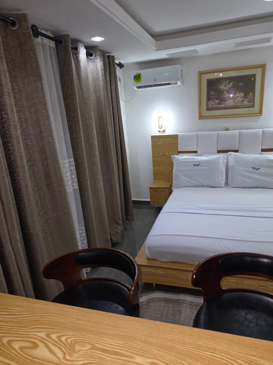 King bed with gold wall lights seen from the breakfast bar