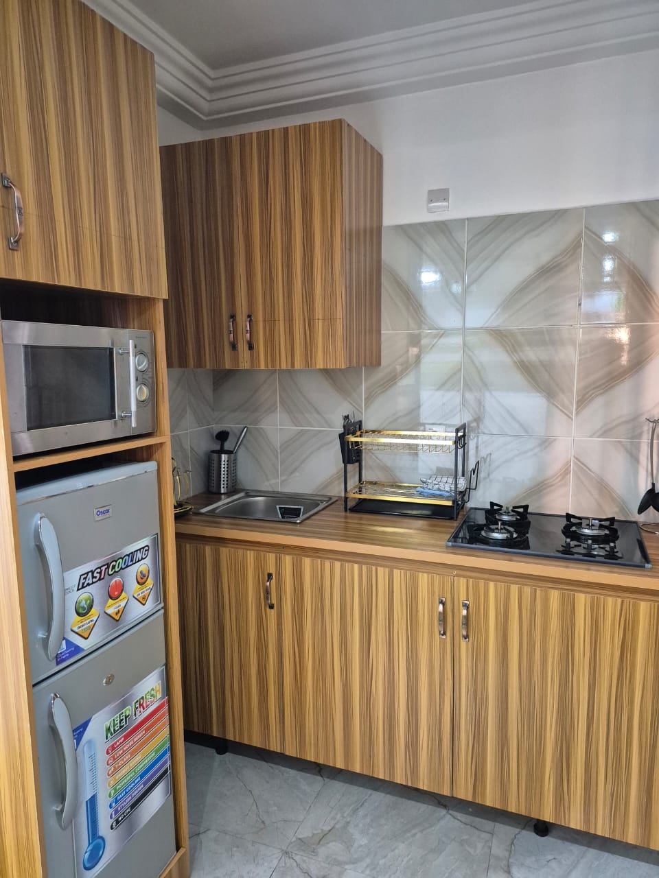 Fitted kitchenette with gas hob, microwave, fridge and sink