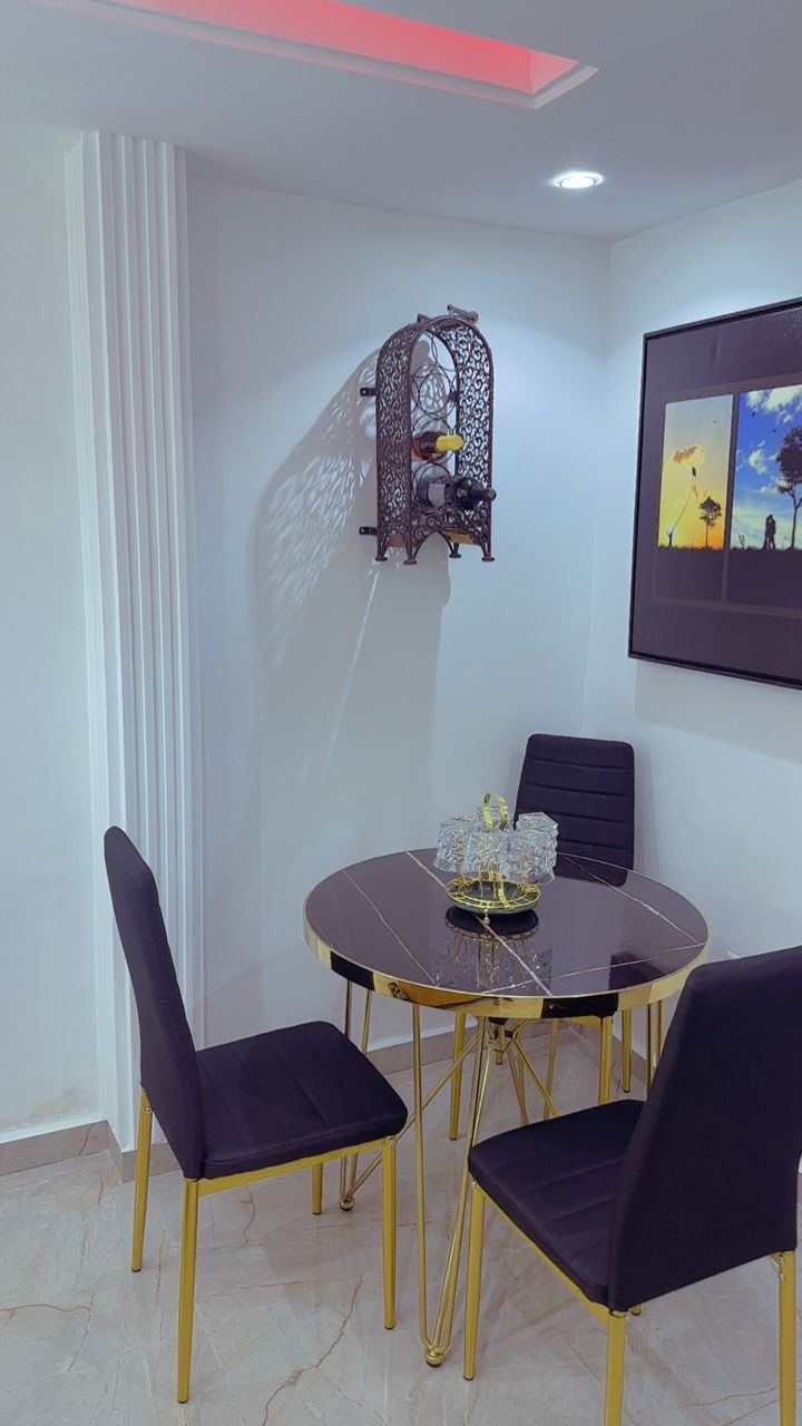 Private dining corner with gold marble table, wine rack and three chairs