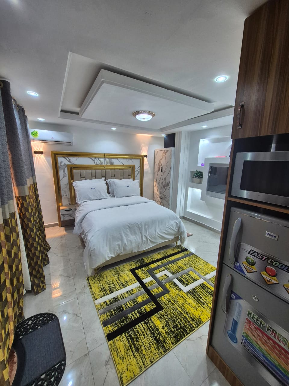 Bedroom seen from the kitchenette, with fridge and microwave
