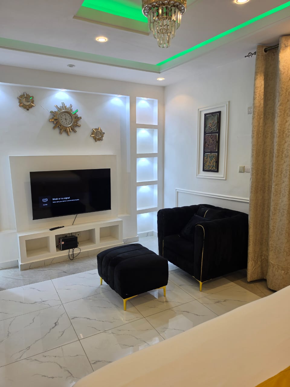 Velvet armchair lounge area with marble floors and ambient lighting